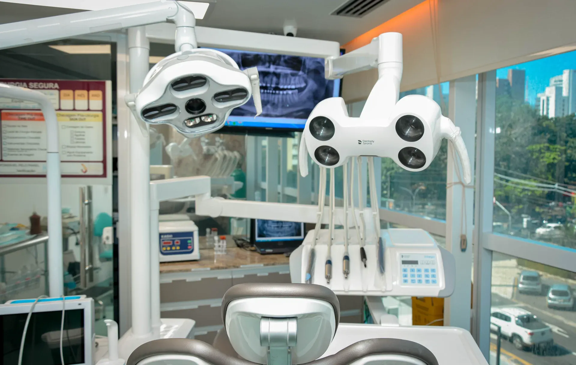 Consultório com cadeira odontológica moderna e vista para a cidade